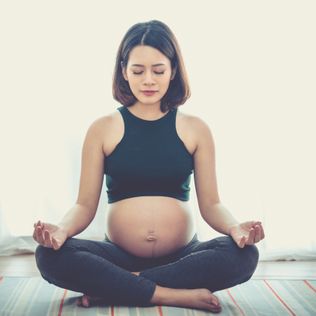 pregnancy, yoga, people and healthy lifestyle concept - happy pregnant